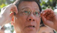 Philippine President Rodrigo Duterte holds his glasses as he speaks to reporters at the presidential palace in Manila, Philippines April 28, 2017. REUTERS/Erik De Castro
