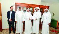 Safar Mubarak Al Shafi (second right), Director, Public Cleaning Department at the Ministry, handing a certificate to Abdullah Al Saadi, Administrative Affairs Director, Amwaj Company.