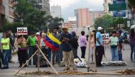 Demonstrators block a street during a protest against Venezuelan President Nicolas Maduro in Caracas, on May 2, 2017.  AFP / RONALDO SCHEMIDT
