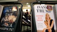 A woman walks past a shelf displaying Ivanka Trump's book 
