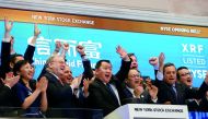 Zhengyu Wang (centre), CEO of China Rapid Finance Ltd., rings the opening bell with company executives and guests to celebrate the company's IPO at the New York Stock Exchange (NYSE) in New York, US.