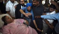 Egyptian national Eman Ahmed Abd El Aty (L) is taken on a stretcher towards an ambulance at a hospital in Mumbai on May 4, 2017.  AFP / PUNIT PARANJPE