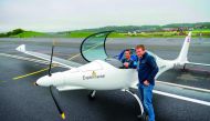 Initiator of the solar-powered plane SolarStratos project, Raphael Domjan (right), poses with test pilot Damian Hischier after the first test flight in Payerne, western Switzerland.