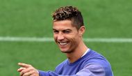 Real Madrid's Portuguese forward Cristiano Ronaldo smiles as he gestures during a training session at Valdebebas training ground in Madrid on May 5, 2017, on the eve of the Spanish League match football match Granada CF vs Real Madrid CF. / AFP / GERARD J