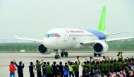 China's home-grown C919 passenger jet returns after completing its maiden flight at Pudong International Airport in Shanghai.
