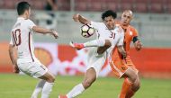 El Jaish's Romarinho (centre) kicks to score during their Emir Cup Quarter-final match against Umm Salal, played at Lekhwiya Stadium yesterday. El Jaish beat Umm Salal  5-3 to reach the semi-finals.