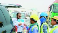 Labourers receiving fresh fruits and awareness cards on World Labour Day.