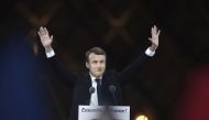 French president-elect Emmanuel Macron greets supporters as he arrives to deliver a speech in front of the Pyramid at the Louvre Museum in Paris on May 7, 2017, after the second round of the French presidential election. / AFP.