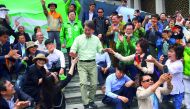 Ahn Cheol-Soo (centre) of the People's Party greets his supporters in Seoul. 