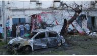 A damaged car and a broken shutter are seen, after a bomb-laden car parked near the Immigration and Citizenship Office exploded, at the explosion site in Mogadishu, Somalia on May 8, 2017. / AA.