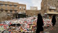Women walk past a pile of rubbish bags on a street during a strike by garbage collectors demanding delayed salaries in Sanaa, Yemen May 8, 2017. REUTERS/Khaled Abdullah
