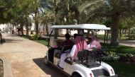 Visitors ride a golf cart at Al Daayen Municipality.