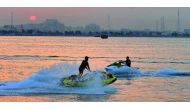 People enjoy the warm weather on jet skis off Doha Corniche yesterday. Pic: Kammutty VP/ The Peninsula