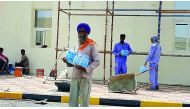 Workers receive water bottles at a construction site.