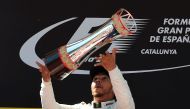 Mercedes' British driver Lewis Hamilton celebrates on the podium after the Spanish Formula One Grand Prix on May 14, 2017 at the Circuit de Catalunya in Montmelo on the outskirts of Barcelona. / AFP / LLUIS GENE
