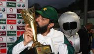 Retiring Pakistan cricket team captain Misbah-ul-Haq kisses the series trophy after winning the final test match and the series 2-1 against the West Indies at the Windsor Park Stadium in Roseau, Dominica on May 14, 2017. (AFP / MARK RALSTON)