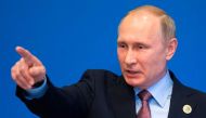 Russian President Vladimir Putin gestures while speaking to the media after the Belt and Road Forum at the China National Convention Center at the Yanqi Lake venue outside Beijing on May 15, 2017. / AFP / POOL / Alexander Zemlianichenko

