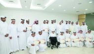 Minister of Education and Higher Education, H E Dr Mohammed bin Abdul Wahid Al Hammadi, with award-winning students and teachers. RIGHT: The Minister  with Ghanim Mohammed Al Muftah, a student at Doha Academy, who is one of the award winners. 