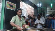 An Indian vendor makes kebabs made from beef at the Tundey Kebabi restaurant in Lucknow on May 17, 2017.  AFP / STR