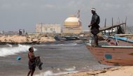 A fisherman stands on his boat on a beach near Kudankulam nuclear power project in the southern Indian state of Tamil Nadu September 13, 2012. REUTERS/Adnan Abidi
