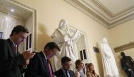 People look at their devices as news comes in that the Justice Department announced that former FBI director Robert Mueller will be a special counsel overseeing the Russia investigation. Mark Wilson/Getty Images/AFP