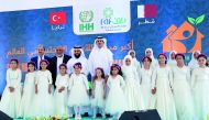Sheikh Dr Khalid bin Thani Al Thani, Chairman of Sheikh Thani bin Abdullah Foundation for Humanitarian Services (RAF), with other officials and Syrian orphans, during the opening of RAF-IHH City for Human Development, in Al Raihaniya, Turkey, yesterday.