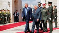 US President Donald Trump (L) and Palestinian leader Mahmud Abbas (2nd L) review the honour guard at the presidential palace in the West Bank city of Bethlehem on May 23, 2017. / AFP / THOMAS COEX.