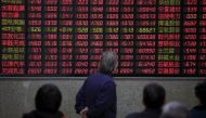  Investors look at an electronic board showing stock information at a brokerage house in Shanghai, China
