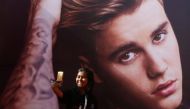 A girl takes a selfie in front of a hoarding outside the venue of Canadian singer Justin Bieber concert in Mumbai, India May 10, 2017. REUTERS/Shailesh Andrade
