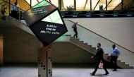 People walk through the lobby of the London Stock Exchange in London, Britain
