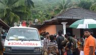 Sri Lankan villagers watch as military rescue workers search for survivors at the site of a mudslide in Bellana village in Kalutara on May 26, 2017.  AFP / Lakruwan Wanniarachchi