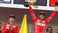 Winner Ferrari's German driver Sebastian Vettel (R) celebrates on the podium next to second placed Ferrari's Finnish driver Kimi Raikkonen after the Monaco Formula 1 Grand Prix at the Monaco street circuit, on May 28, 2017 in Monaco. / AFP / ANDREJ ISAKOV