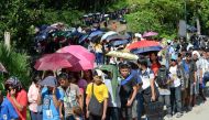 Residents and commuters queue up at a police checkpoint at the entrance to Iligan City on the southern island of of Mindanao on May 29, 2017, after local authorities locked down the city due to a terror threat. AFP / Ted ALJIBE
