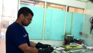 An inspector checking a fish-selling outlet, where 150kg  of fish unfit for consumption has been destroyed.
