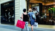 Shoppers pass a Jimmy Choo Plc luxury footwear store in Paris, France, recntly.