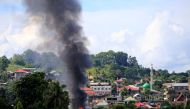 Smoke billowing from a burning building is seen as government troops continue their assault on insurgents from the Maute group, who have taken over large parts of Marawi City, Philippines June 1, 2017. REUTERS/Romeo Ranoco