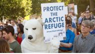 Protesters hold up signs during a demonstration in front of the White House in Washington, DC on June 1, 2017, objecting to US President Donald Trump's decision to withdraw from the Paris Climate accord. (AFP / PAUL J. RICHARDS)