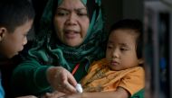 A volunteer doctor tends to a boy that was trapped for 11 days with his family at Pangarungan Village in Marawi City, on the southern island of Mindanao on June 3, 2017. AFP / RODY
