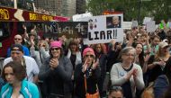 People hold signs at the March for Truth on June 3, 2017 in New York. The marchers are calling for a fair and impartial investigation into alleged Russian influence in 2016 US elections and for US President Donald Trump to release his tax returns. (AFP / 