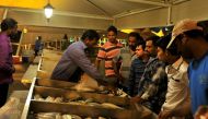 (File photo of people buying fish from the Doha Corniche. Photo by Baher Amin)