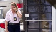 A law enforcement official wipes her eyes at the entrance to the shooting crime scene in Orlando, Florida on June 5, 2017. AFP / Gregg Newton