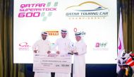 Saeed Al Sulaiti receiving winner's cheque of QR 100,000 from QMMF President Abdulrahman Al Mannai and LCSC Vice- President and General Manager Khalid Al Remaihi at Ritz Carlton yesterday.
