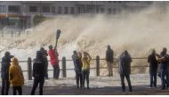 CAPE TOWN, SOUTH AFRICA - JUNE 7: People stand over the bridge as the huge waves hit coastline during the heavy storm in Cape Town, South Africa on June 7, 2017. ( Ashraf Hendricks - Anadolu Agency ).