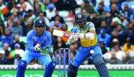 Sri Lanka's Kusal Mendis (right) hits a shot watched by India's MS Dhoni during the match.