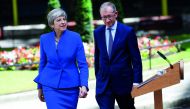 Britain's Prime Minister Theresa May returns to Downing Street with her husband Philip after travelling to Buckingham Palace to ask the Queen's permission to form a minority government, in London, yesterday. 