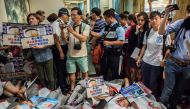 Shark fin activists protest outside Maxim's flag ship restaurant 'Maxim's Palace', the largest Chinese restaurant group, for selling threatened and endangered shark species in Hong Kong on June 10, 2017. / AFP.