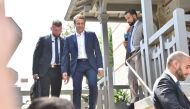 French President Emmanuel Macron (C) leaves his home in Le Touquet, northern France, on June 11, 2017, during the first round of France's legislative elections.   AFP / Philippe HUGUEN

