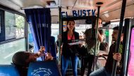 Maria Gabriela Fernandez (C) gives a presentation of the Bus TV news in Caracas, Venezuela, on June 6, 2017. A group of young Venezuelan reporters board buses to present the news, as part of a project to keep people informed in the face of what the opposi