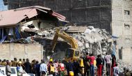 Emergency personnel work at the scene after a building collapsed in a residential area of Nairobi, Kenya June 13, 2017. REUTERS/Baz Ratner 