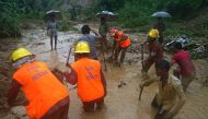 Bangladeshi fire fighters and residents search for bodies after a landslide in Bandarban on July 13, 2017. Heavy monsoon rains have killed at least 46 people in southeast Bangladesh, most of them buried under landslides, authorities said on July 13.   AFP